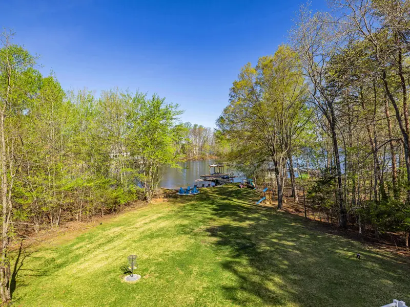 Backyard Bliss: A massive green lawn leading straight to the waterfront.
