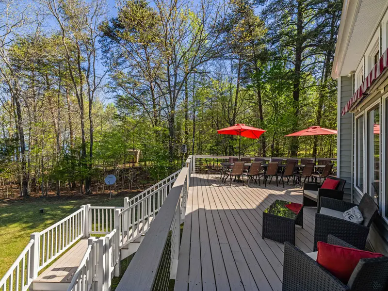 Backyard Retreat: A peaceful view of the property from the deck railing.