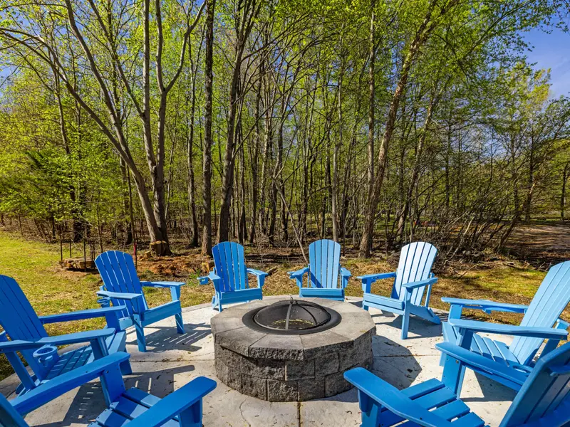 Fire & Water: Cozy blue Adirondack chairs around the stone fire pit.