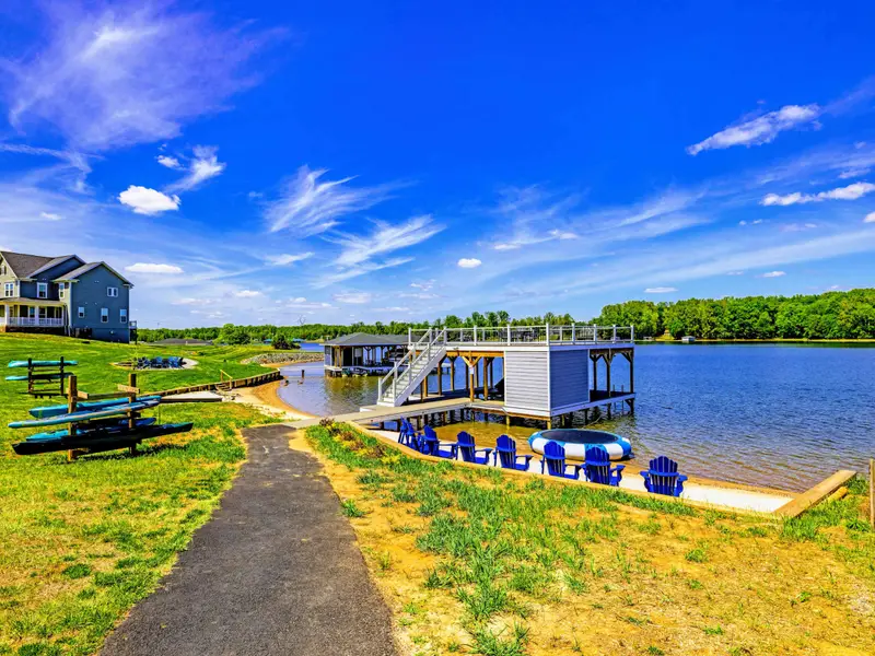 Backyard & Beach - The walk down: open lawn, kayak rack ready to grab and go, dock and chairs waiting at the water.