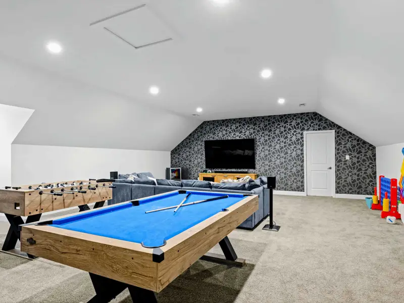Game Room - Pool, foosball, giant Connect 4, and a deep sectional facing the TV, room for the whole crew to land.