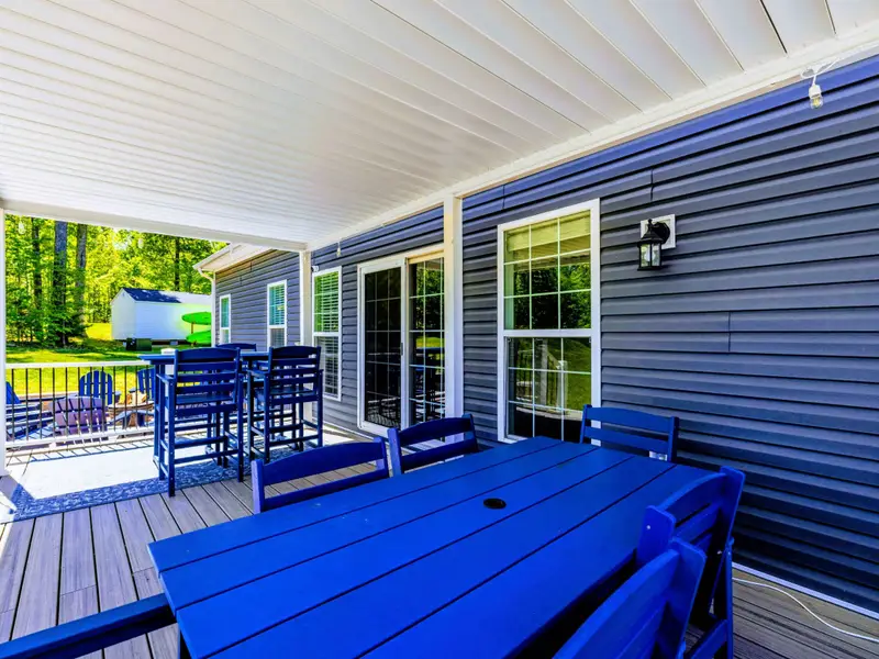 Back Porch - The full porch lineup: dining table, bar-height stools, and the fire pit just beyond.