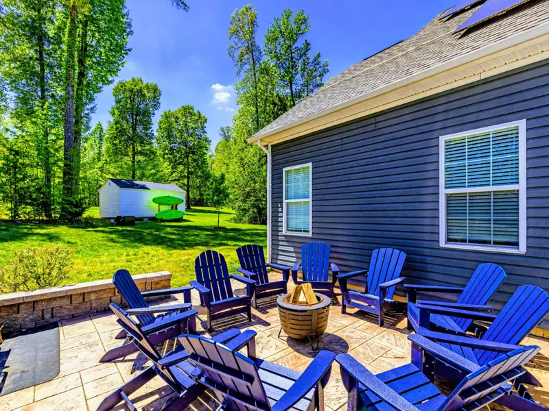 Fire Pit - A circle of blue Adirondacks around the bowl, grill at the ready for an easy night outdoors.