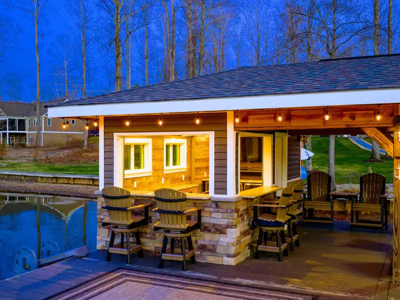 Backyard - A green lawn slopes toward the dock, framed by quiet coves and open water beyond.