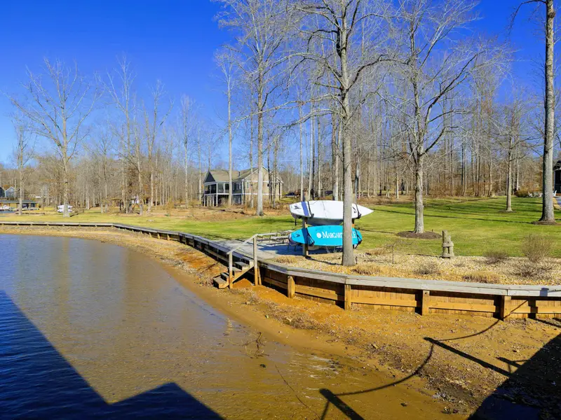 Backyard - Lakefront orientation captures soft morning light and golden sunsets across the cove.