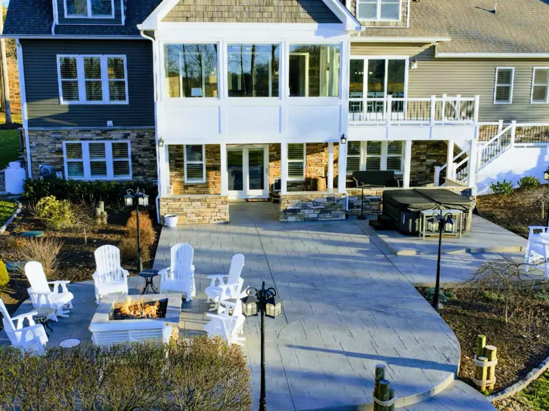 Patio - The back patio anchors the outdoor space up at the house, with shaded seating and lake views down the sloped lawn.