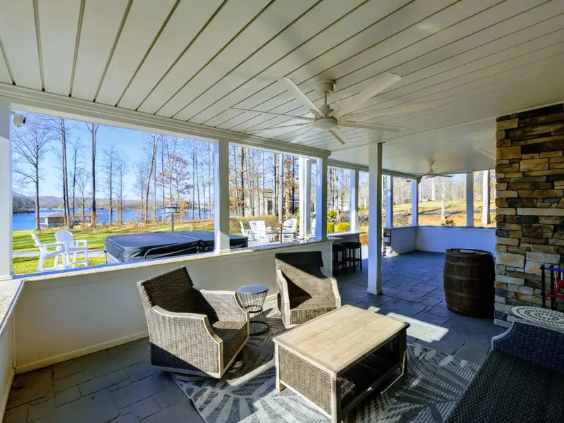 Patio - The back patio anchors the outdoor space up at the house, with shaded seating and lake views down the sloped lawn.