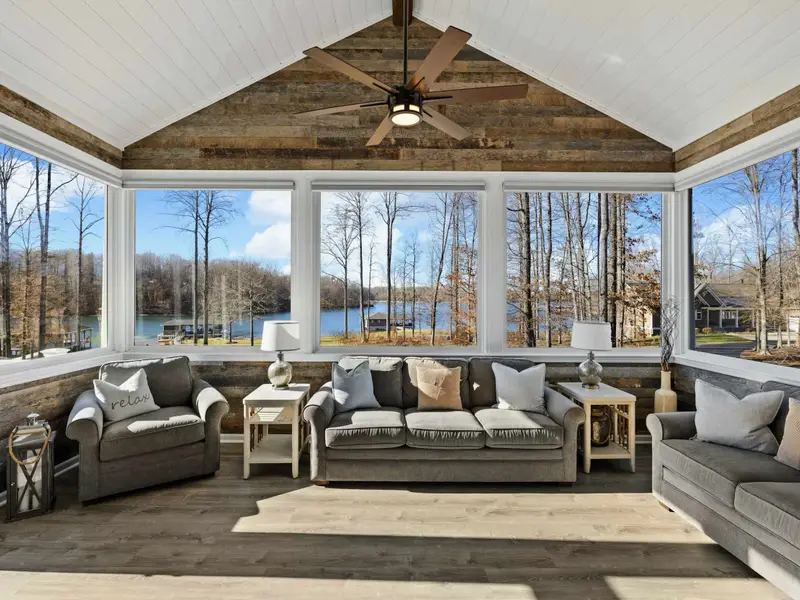 Sun Room - Floor-to-ceiling windows pull the lake inside, a warm space year-round.