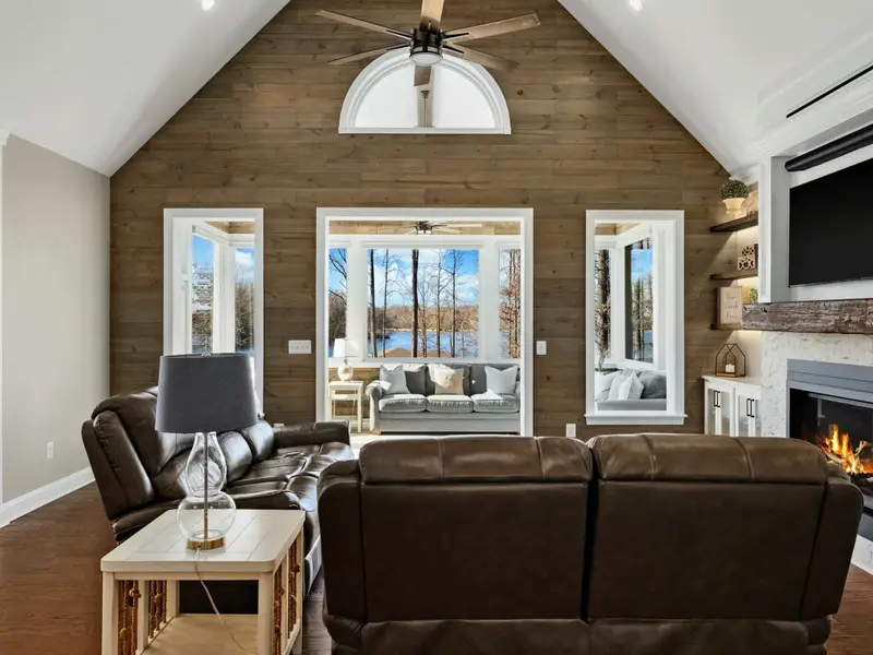 Great Room - Vaulted ceilings and walls of windows frame the lake, keeping the whole group connected.