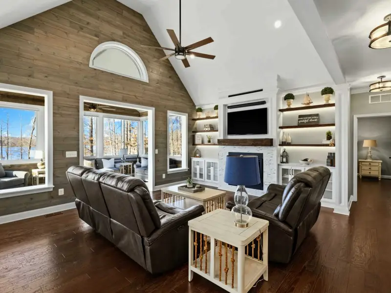Great Room - Open floor plan with comfortable seating, a gas fireplace, and uninterrupted lake views.