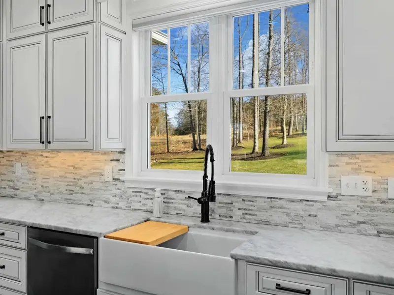 Kitchen - Gourmet kitchen with island seating, double oven, and stainless appliances for serious cooks.