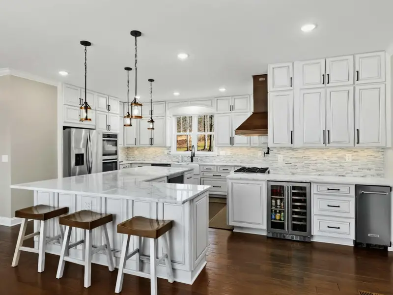 Kitchen - Gourmet kitchen with island seating, double oven, and stainless appliances for serious cooks.