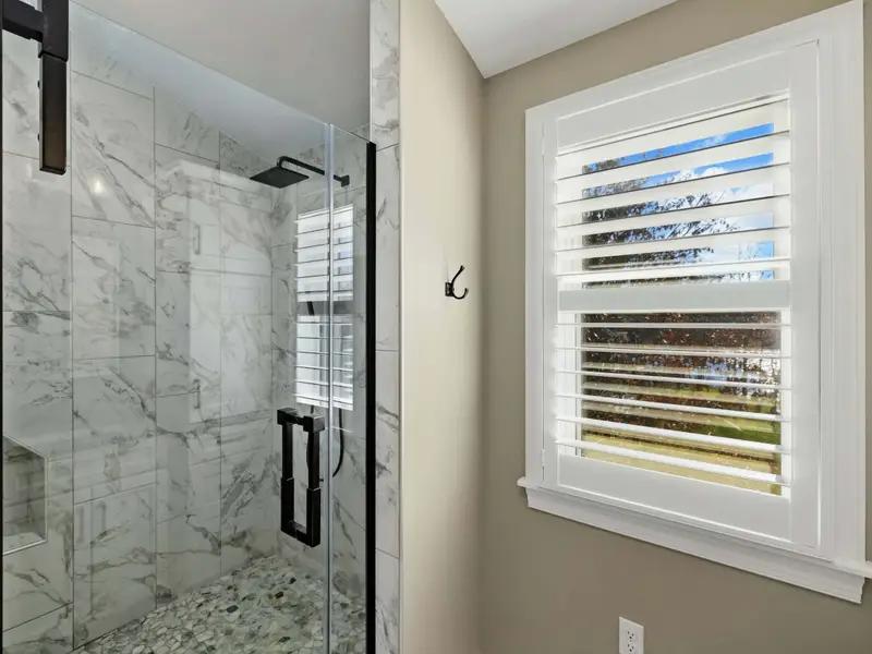Upper Level Bedroom - Soft linens, attached bath, and quiet upper-level views.