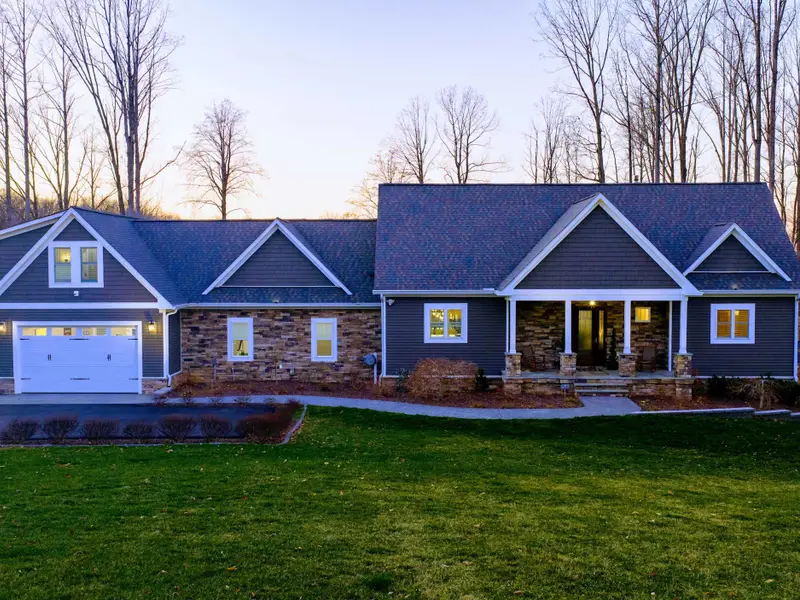 Exterior - Three-story Craftsman set on a level 1.34-acre lot with mature landscaping.