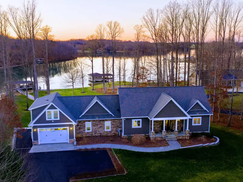 Exterior - Front-of-house view, with the attached two-car garage and ample driveway parking for guests.