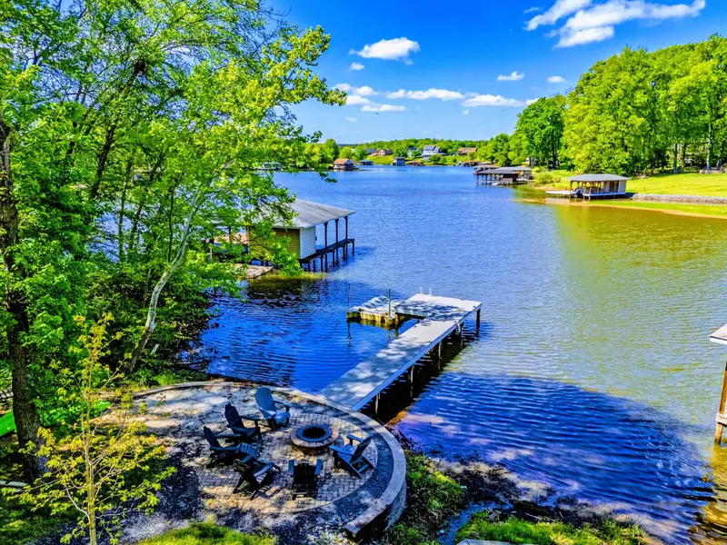 Dock - Coffee in hand, bare feet on the dock, the lake still and golden at sunrise.