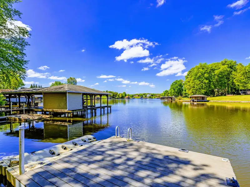 Aerial View - The home, the cove, and the dock from above on a sunny Lake Anna afternoon.