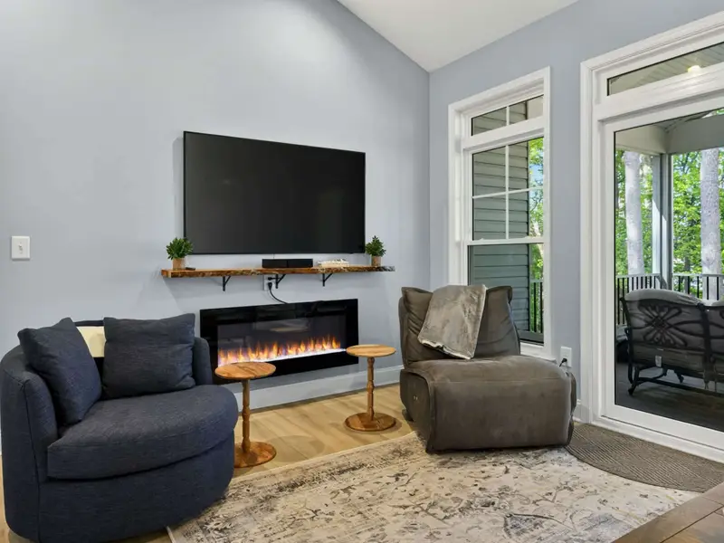 Great Room - Light wood floors and a calm gray-blue palette throughout.