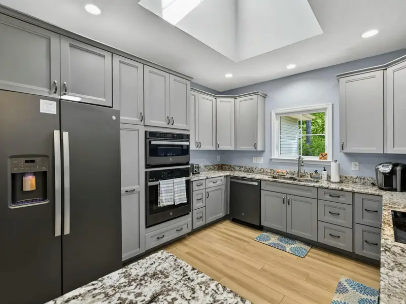 Kitchen - Induction cooktop with stainless vent hood, ready for serious cooking.