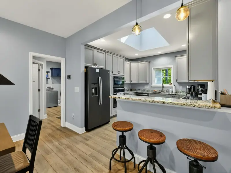 Dining - Pendant lighting over the bar keeps the area bright and welcoming.