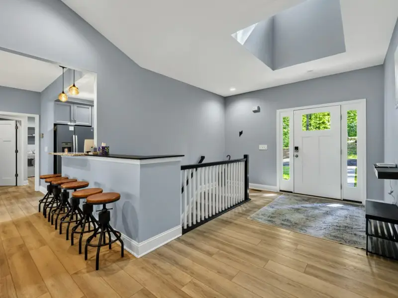 Dining - Bar seating for five at the breakfast counter with light wood stools.