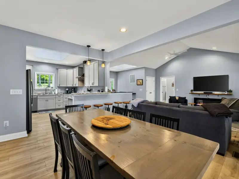 Dining - Light wood floors and pale gray walls give the space a calm feel.