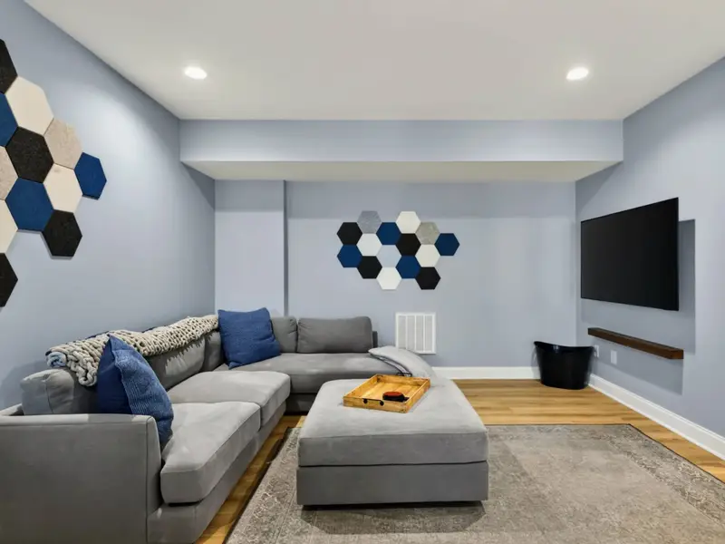 Game Room - Light blue walls and oak floors keep things bright underground.
