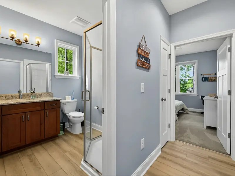 Hall Bath (Main) - Walk-in tile shower with dual vanity, serves Bedrooms 3 and 4.