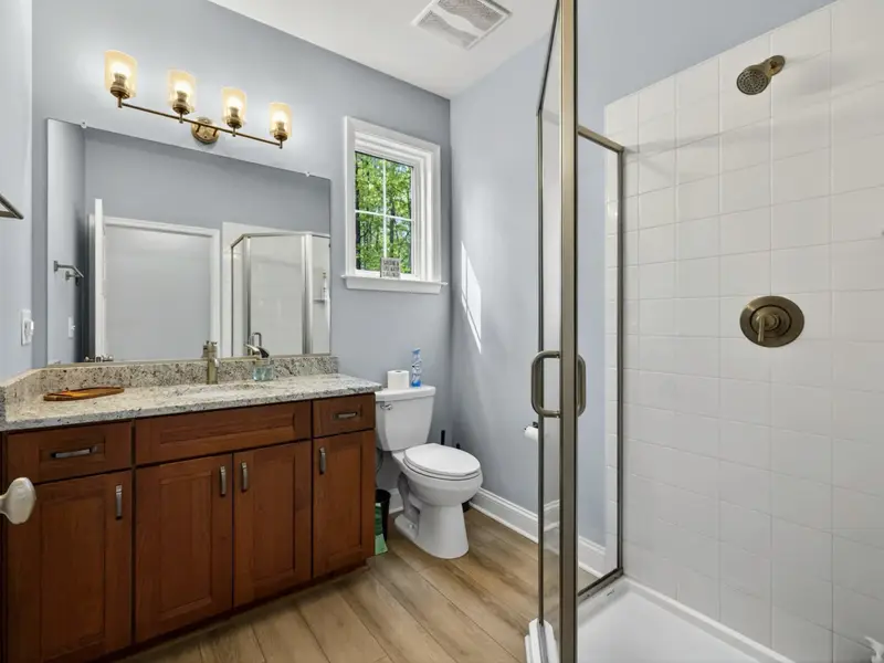 Hall Bath (Main) - Brass fixtures and modern finishes throughout.