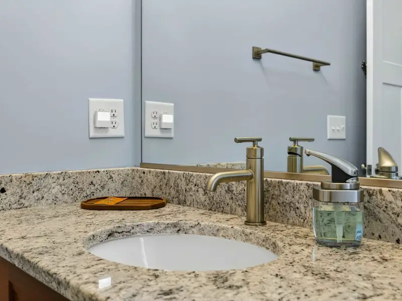 Hall Bath (Main) - Plenty of counter space for two, with a bright window.