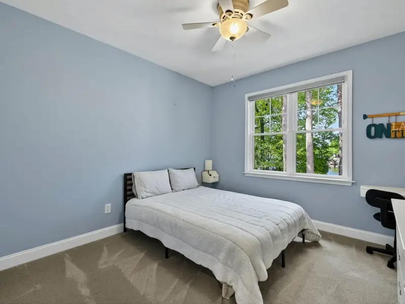 Bedroom 3 - Main-level queen bedroom with cove view and a dedicated workspace.