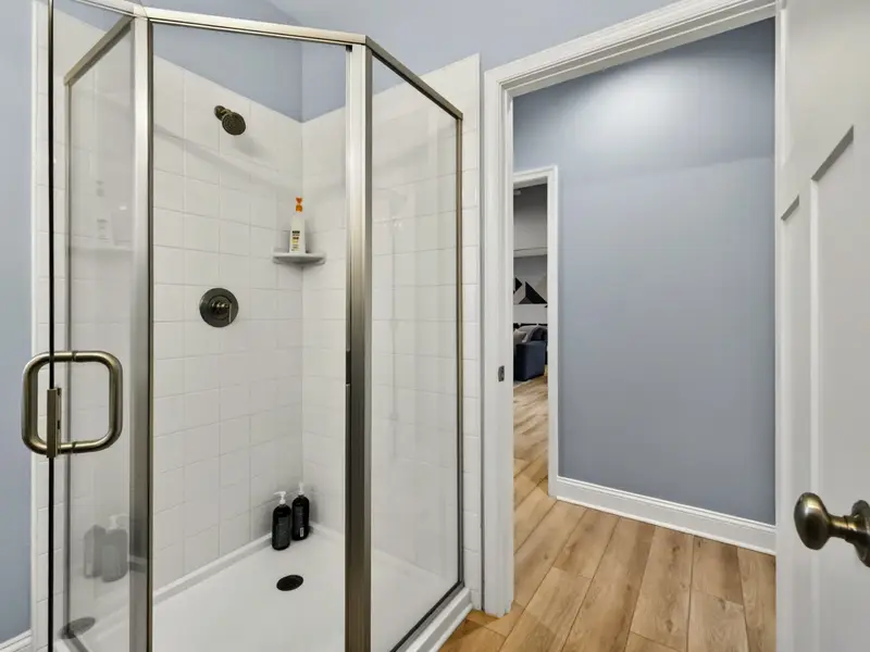 Hall Bath (Main) - Dark slate floors with light wood vanity for a polished look.