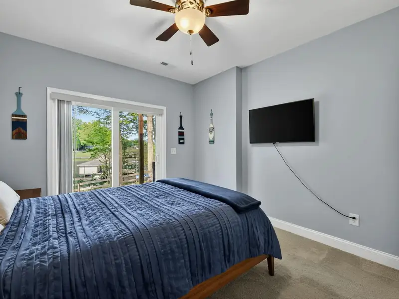 Bedroom 5 - Lower-level queen bedroom with cove view and patio access.