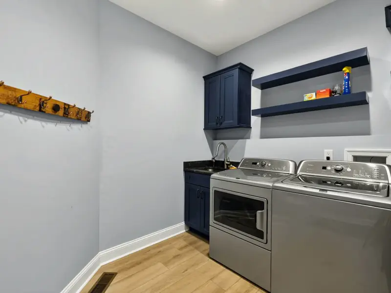 Laundry - Cabinet storage and counter space make turnover effortless.
