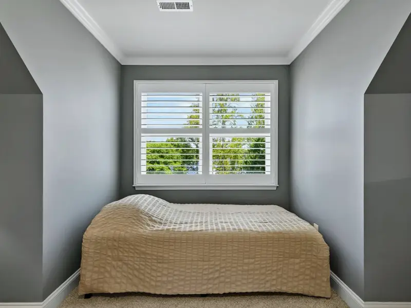 Upper Level Bedroom - Twin tucked into the dormer nook, framed by plantation shutters, the favorite spot for a younger guest with their own window.