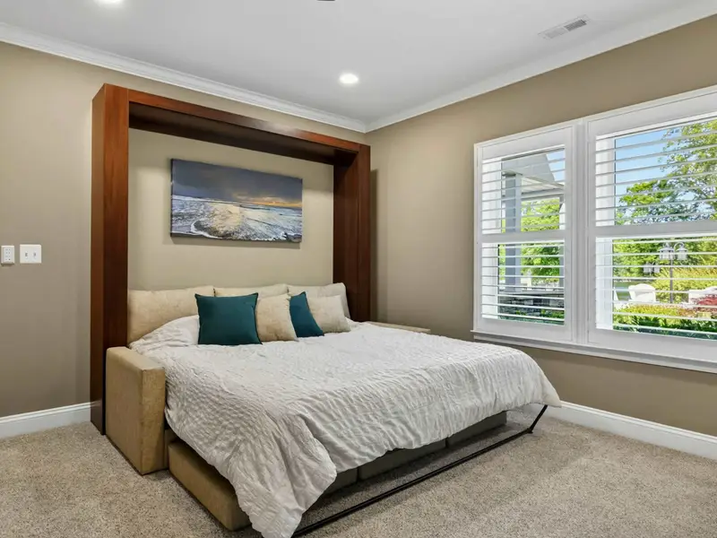 Bunk Room - King Murphy bed pulled down with crisp linens and a lakefront print above, the grown-up side of the kids' favorite room.