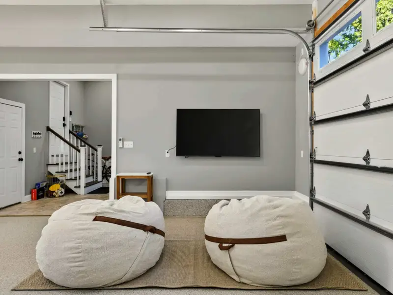 Game Room - Big TV, oversized beanbags, and the original garage door behind, the spot where the lounge crowd meets the gamer crowd.