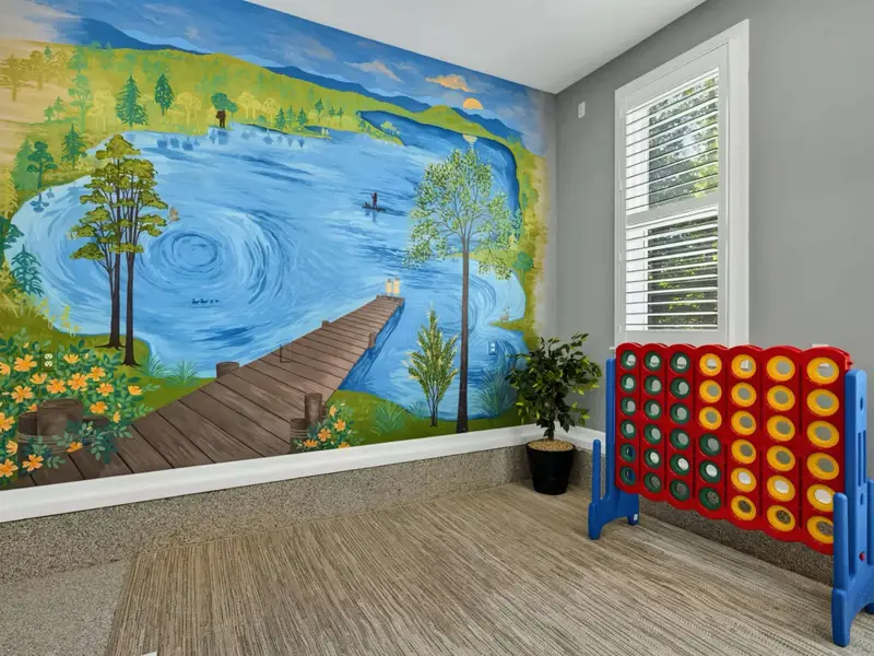 Game Room - A hand-painted Lake Anna mural anchors the wall behind the giant Connect Four, a quiet detail that becomes a family favorite.