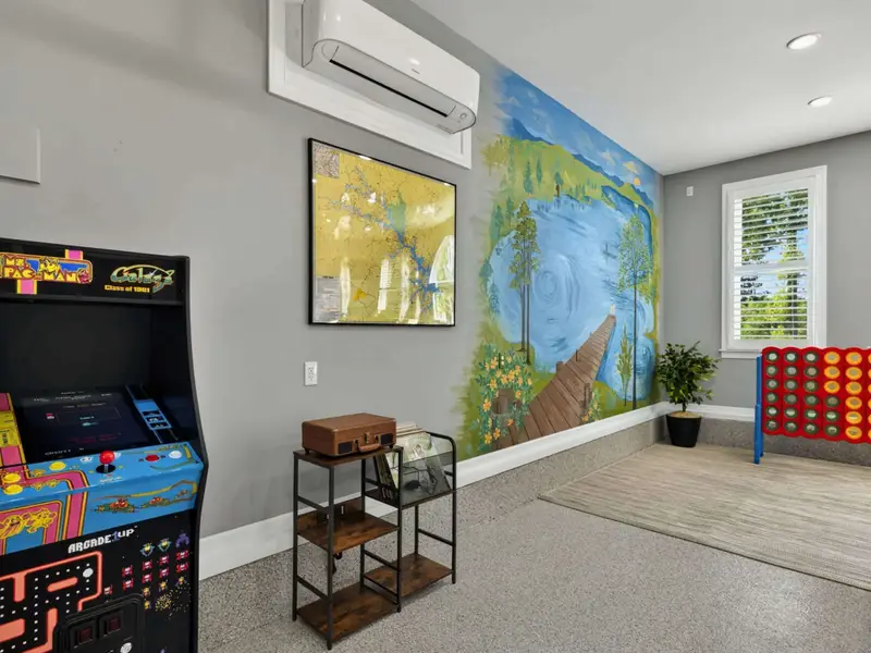 Game Room - Ms. Pac-Man and Galaga in the corner, with a hand-painted lake mural keeping the lake in the room even on rainy afternoons.