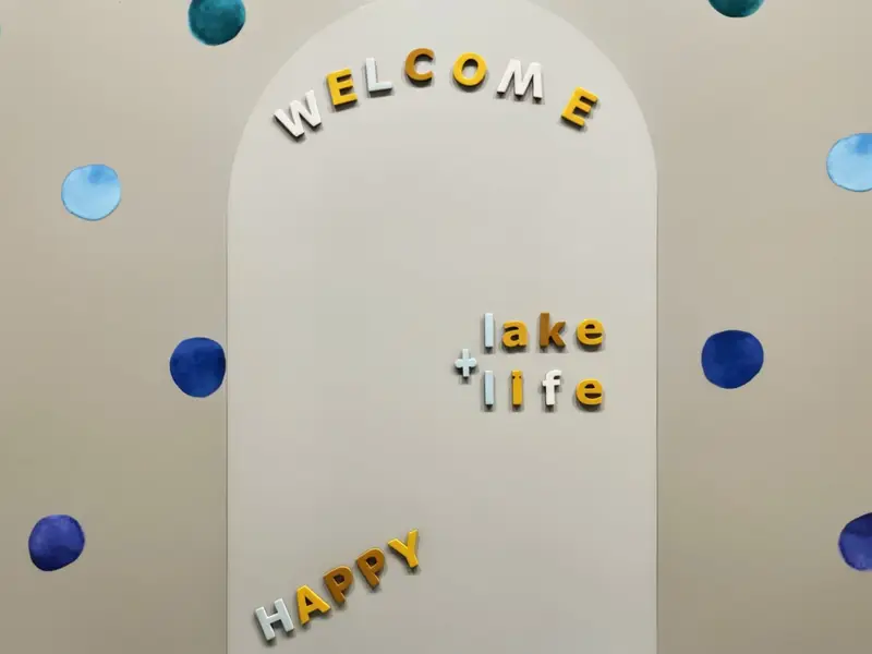 Children's Playroom - 'Welcome to lake life, happy' painted on the climbing wall arch, an invitation little kids spot before the grown-ups do.