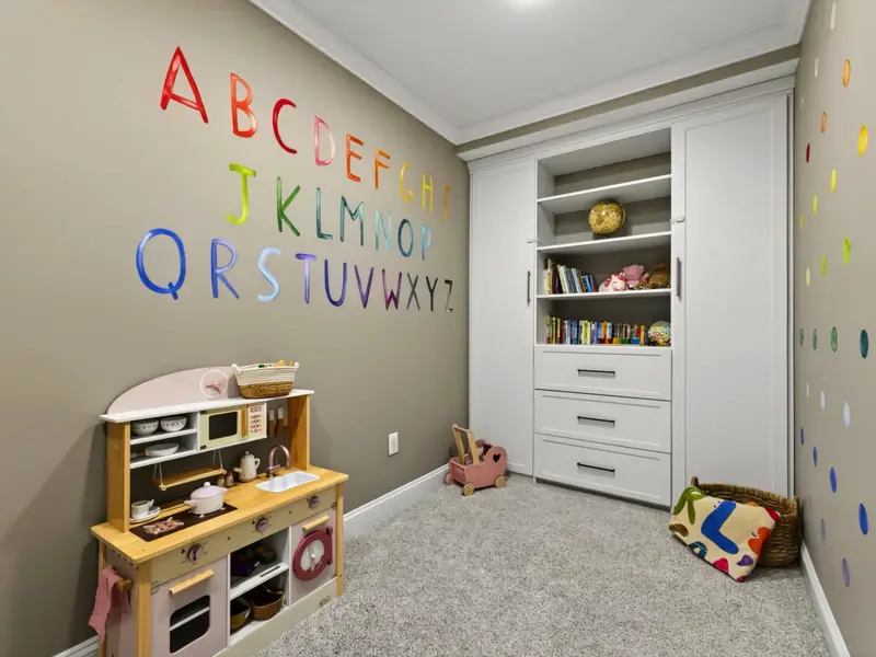 Children's Playroom - Soft carpet, a play kitchen, and a wall-painted alphabet, designed for hours of pretend without the toys ever following you upstairs.