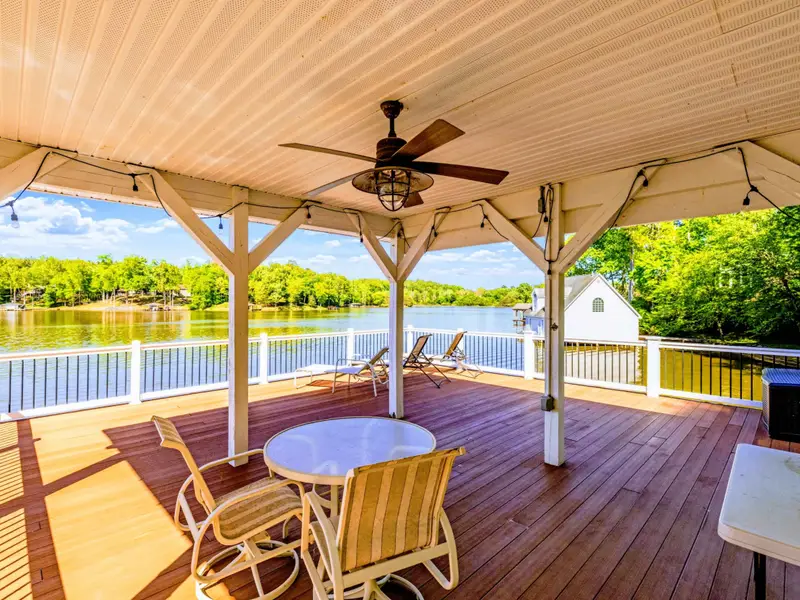 Dock - Round dining table on the dock, set up for waterside meals and long conversations.