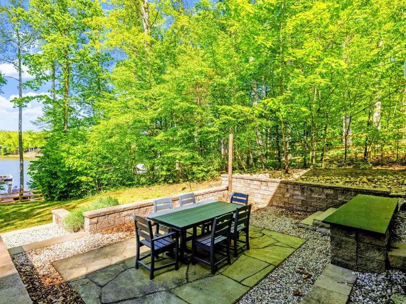 Backyard - Mature trees and an open lawn, with the lake just past the dock.