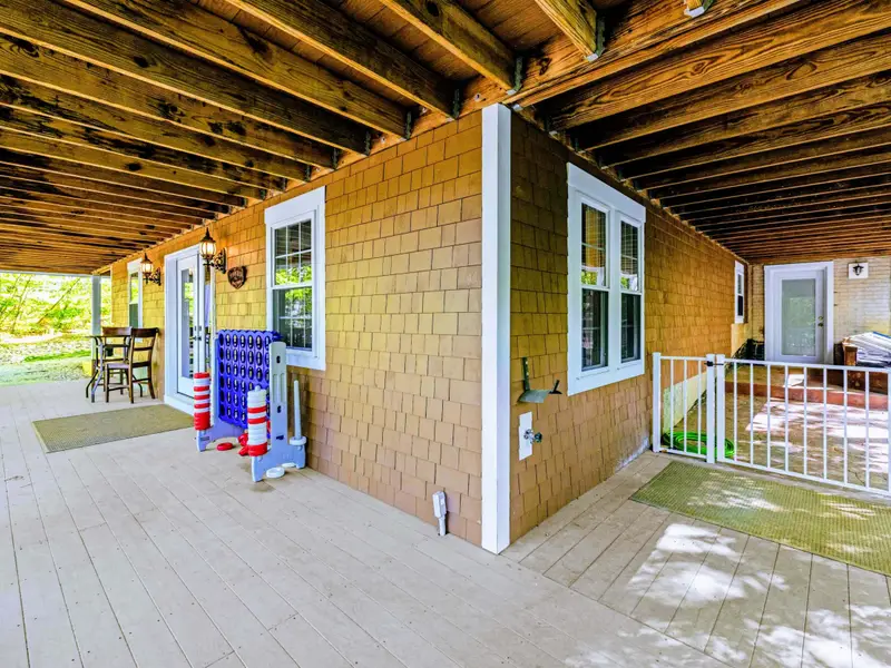 Lower Porch - Covered ground-level porch with seating and views straight out to the lake.