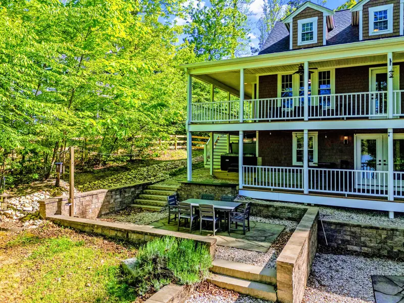 Patio - Layered decks step down the hillside toward the dock and lake.