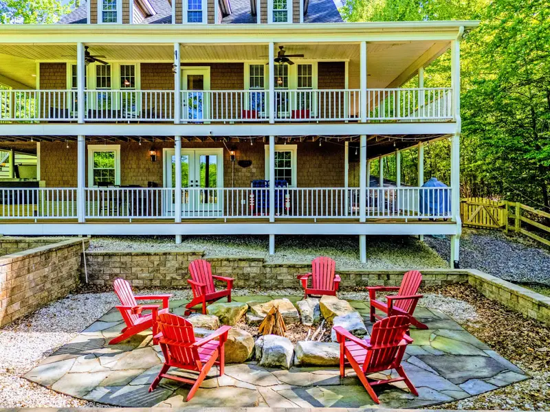 Fire Pit - A circle of red Adirondack chairs around the backyard fire pit, where most evenings end.