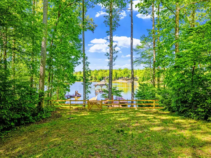 Backyard - A wide-open grassy lawn between the house and the dock, easy access for everyone.