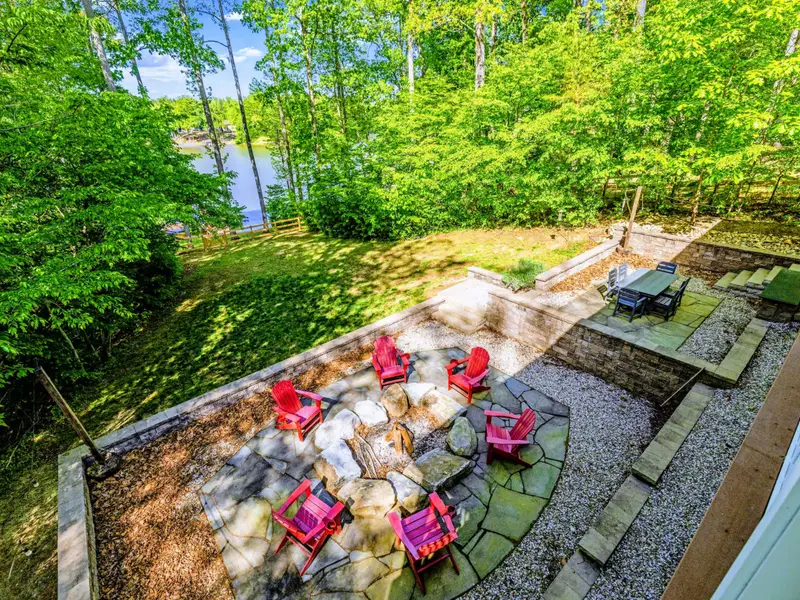Upper Porch - Sweeping views of the patio, lawn, and lake.