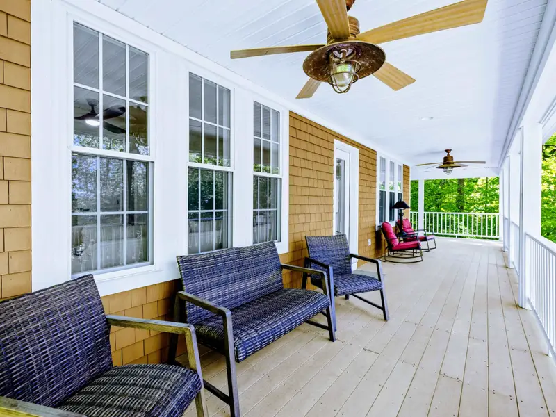 Upper Porch - The corner of the porch with seating angled to catch the lake view through the trees.