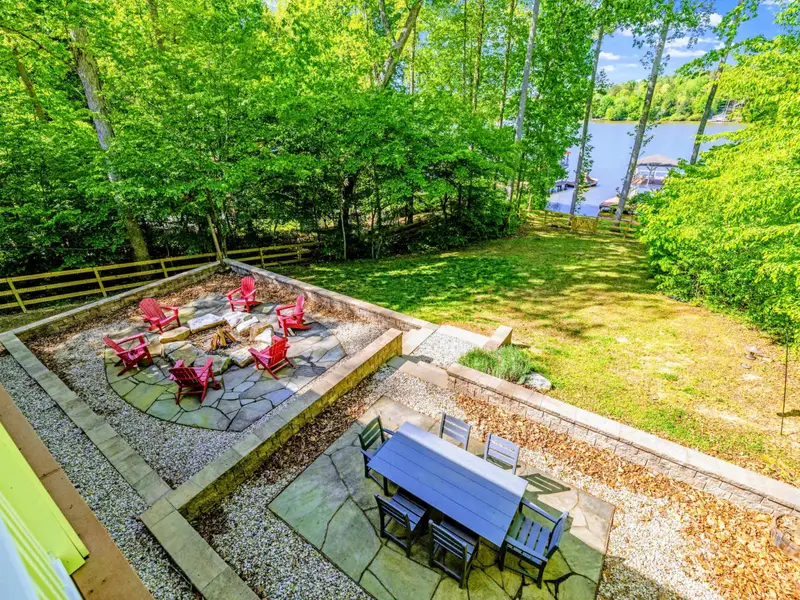 Upper Porch - From the upper porch, the fire pit area and lawn unfold below you.